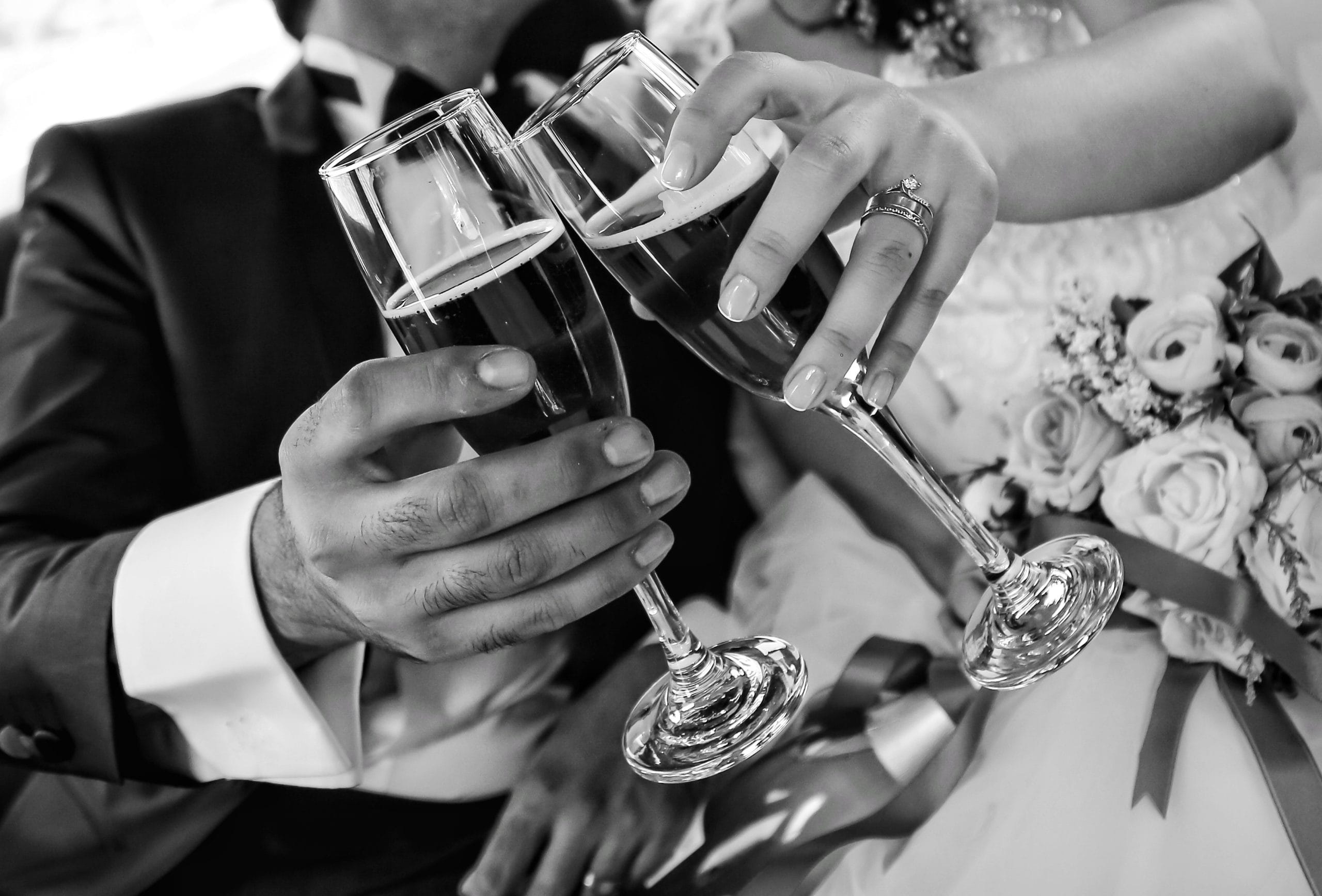 bride and groom toasts in car